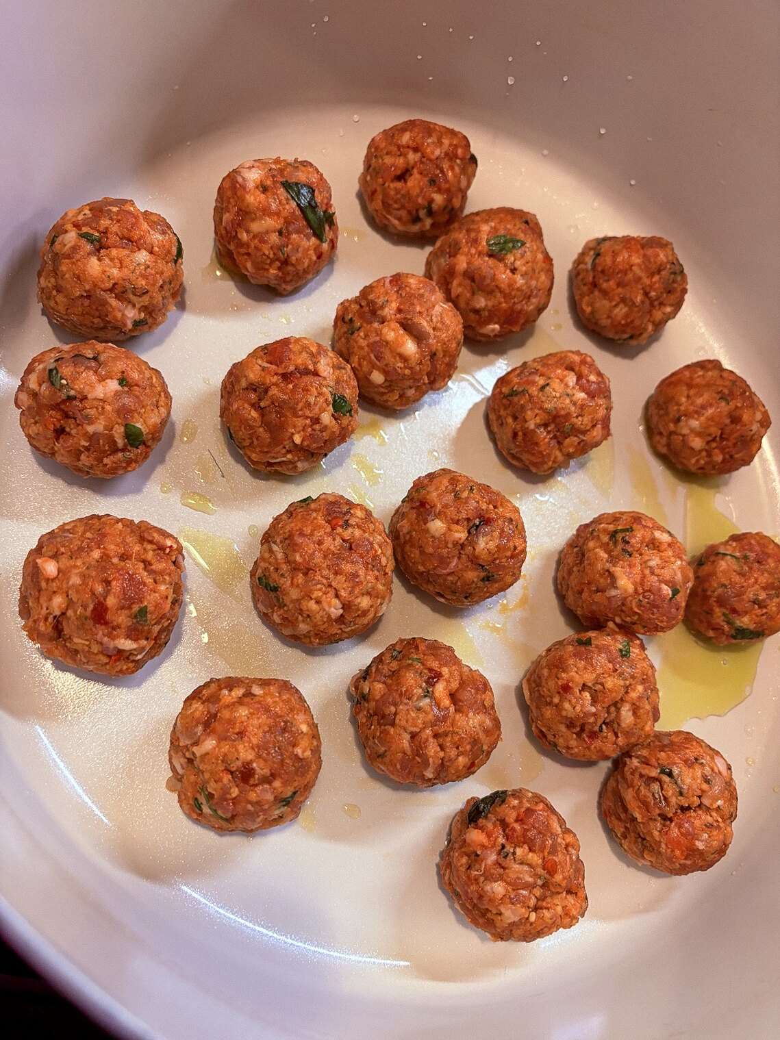 Hand-rolled spicy Italian sausage meatballs ready to cook